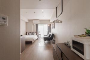 a hotel room with a bed and a living room at LANG HOTEL Kameido - Vacation STAY 76905v in Tokyo