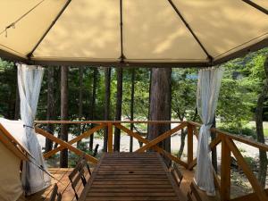a porch of a tree house with a wooden deck at Riverside Glamping Nuts - Vacation STAY 78012v in Yamakami