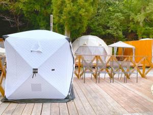 two tents on a deck with tables and chairs at Riverside Glamping Nuts - Vacation STAY 78071v in Yamakami