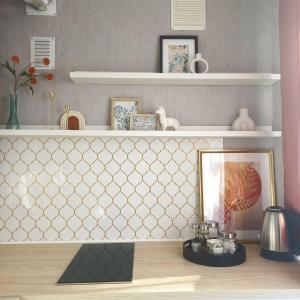 a shelf with a mirror and a picture on a desk at Narva Vibe Apartment in Narva