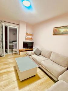 a living room with a couch and a table at dorian beach appartment 4 in Durrës