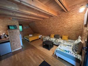 a living room with a couch and a bed in a room at La Petite Motte in Ceton