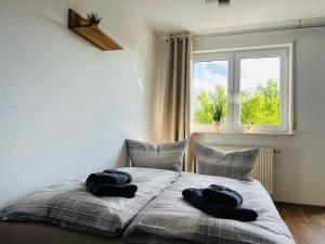 a bedroom with a bed with two towels on it at Apartment Arjen in Pirna