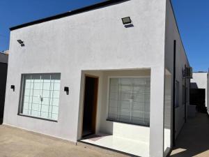 a white house with large windows and a door at Ótima casa Termas Olímpia in Olímpia