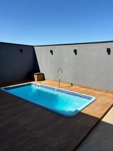 a bath tub with a faucet in a room at Ótima casa Termas Olímpia in Olímpia