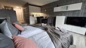 a large bed in a living room with a tv at Premium Apartment Wohlfühl-Oase mit Pool und Sauna in Sankt Englmar
