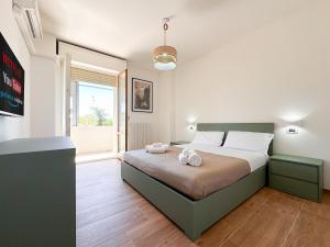 a bedroom with a bed with two towels on it at Modena Skyline - View on Ghirlandina in Modena +16 photos