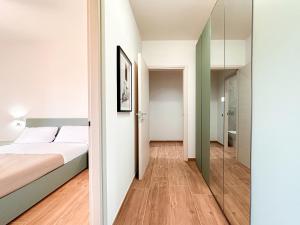 a bedroom with a bed and a mirror at Modena Skyline - View on Ghirlandina in Modena