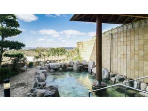 a pool of water with rocks in front of a building at Ouka no sato La-Foret Shobara - Vacation STAY 67406v in Shōbara