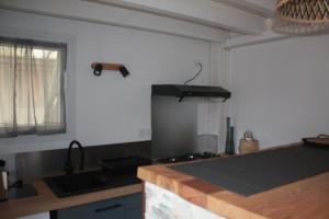 a kitchen with a sink and a counter top at Anna in Lacanau