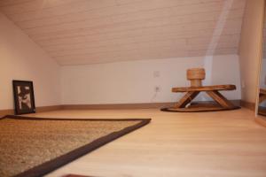 an empty room with a table and a rug at Anna in Lacanau