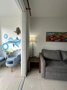 a living room with a couch and a table at Playa Azul House in Bayahibe