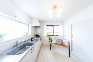a white kitchen with a sink and a window at Yokkaichi - House - Vacation STAY 19181 in Yokkaichi +33 photos