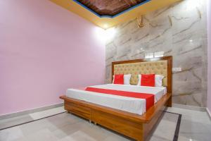 a bedroom with a bed and a stone wall at Hotel O Grand City in Chandīgarh +22 photos