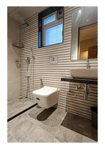 a bathroom with a toilet and a sink at Sukoon by PEP stays in Lonavala