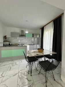 a kitchen with a table and chairs in a room at Apartment Sunset Zone - Feels like home in Lozovo