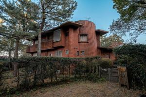 a large brick house with a tower on top of it at Villa Mille - Vacation STAY 19589 in Ito +4 photos
