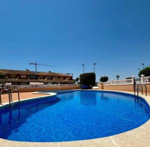 a large blue swimming pool in a building at Casa Kave Euro Roda-Los Alcazares in Los Alcázares