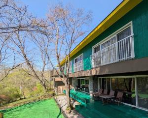 a green house with a table and chairs in front of it at Nasu Green Onsen - Vacation STAY 19256 in Nasu-yumoto