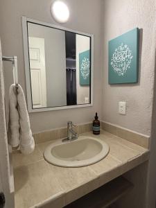 a bathroom with a sink and a mirror at Acogedor apartamento minimalista Mai in Puerto Vallarta +13 photos