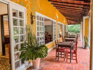 a dining room with tables and chairs on a patio at Recanto Quinta da Jade in Itaipava