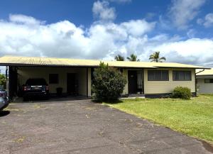 a house with a car parked in front of it at Master Suite with Private Bath 15 min drive to beach in Hilo