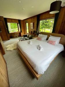 a bedroom with a large bed with two stuffed animals on it at The Lakehouse at Toyako - Vacation STAY 44249v in Tōya