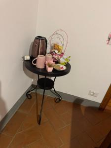 a small table with a coffee maker on it at La Mora Affittacamere in Tuoro sul Trasimeno