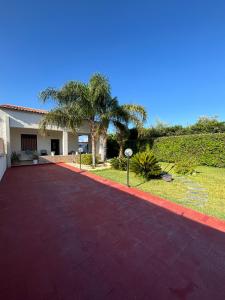 a red brick walkway in front of a house at Mori & Zagara in Fanusa