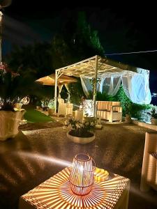 a table with a lamp sitting on top of it at Villa Rosa in Agropoli