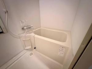 a white bath tub in a small bathroom at Park Hills OM Chuo 12 - Vacation STAY 19390 in Sapporo +34 photos
