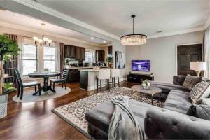 a living room with a couch and a table at Enchanting 1br Retreat Tree-lined Swiss Ave in Dallas