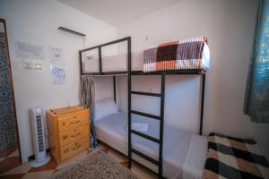 a bedroom with two bunk beds and a dresser at Dar Oussama in Rabat