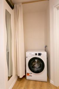 a washing machine in a laundry room with a window at Corte di Raglio in Cunardo