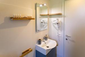 a bathroom with a sink and a mirror at Corte di Raglio in Cunardo +13 photos