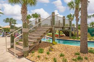 a wooden bridge over a pool at a resort at Near Disney 4BR with Private Pool in Kissimmee