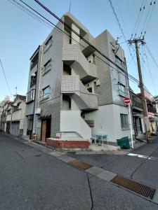 a building with stairs on the side of a street at Guesthouse Mulberry Kagoshima- Vacation STAY 50746v in Kagoshima