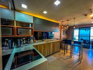 a kitchen with a counter and some bar stools at Beira Mar Fortaleza Landscape in Fortaleza