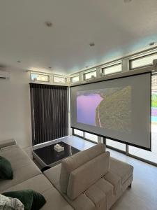 a living room with a large screen television at Onjuku Garden Villa - Vacation STAY 54392v in Iwada