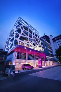 a building with a car parked in front of it at favehotel Gatot Subroto Jakarta in Jakarta