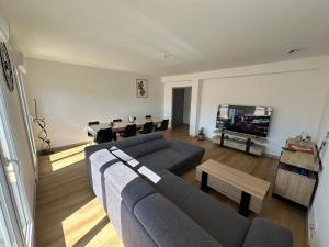 a living room with a couch and a table at Appartement climatisé in Château-Arnoux-Saint-Auban