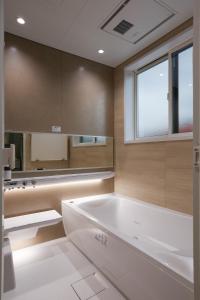 a bathroom with a white tub and a window at Fuji Petel - Vacation STAY 56350v in Azagawa +24 photos