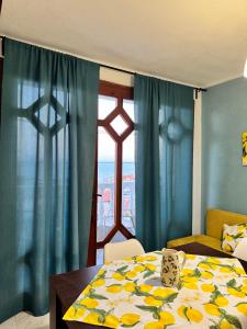 a dining room with a table and a window at Villa Nikoleta in Sveti Vlas