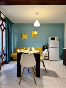 a kitchen with a table and chairs and a couch at Villa Nikoleta in Sveti Vlas