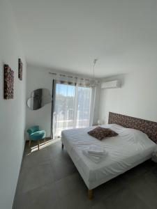 Un dormitorio con una cama y una silla y una ventana. en Villa Mamago, en Cirendinu