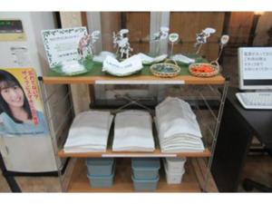 une étagère avec un livre et d'autres articles y afférents dans l'établissement Smile Hotel Hachinohe - Vacation STAY 56439v, à Hachinohe