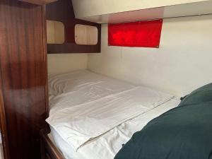 a bed in a small room with a red window at Catamaran El Pelegrino in Les Anses-dʼArlets +14 photos
