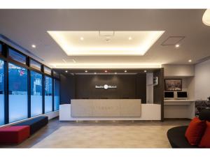 a lobby with a reception desk in a building at Smile Hotel Hiroshima - Vacation STAY 77672v in Hiroshima