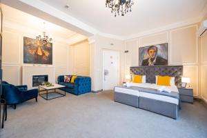 a bedroom with a king sized bed and a couch at Kings Palace Suites in Belgrade
