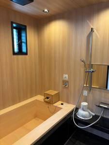 a bathroom with a bath tub with a shower at Awaji Island Ayayagumi Waterfall Terrace - Vacation STAY 81025v in Ōno